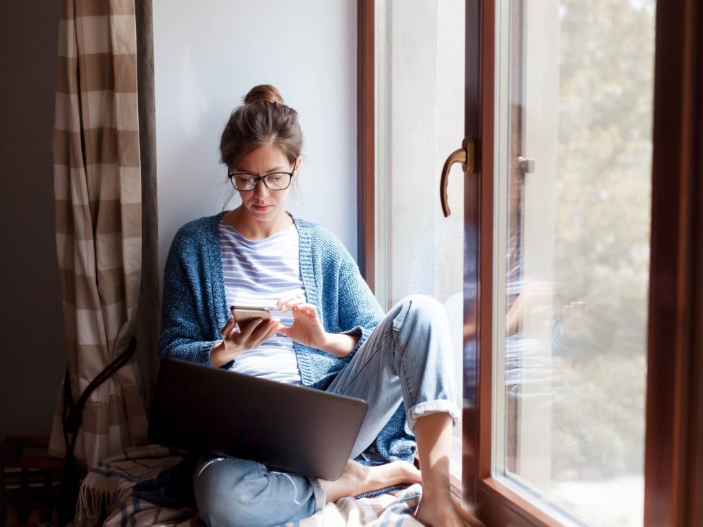 girl with phone laptop